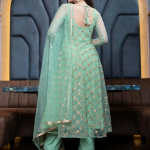 Green and gold-toned embroidered semi-stitched dress material